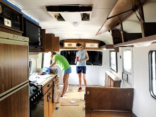 DeLisle and Goelz working on the interior of their 1986 Fleetwood Avion RV.