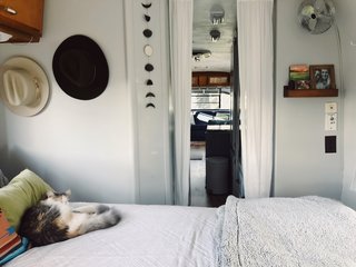 The bedroom features a down alternative duvet insert from Target, a throw blanket from Homegoods, and a green velvet lumbar pillow from World Market.