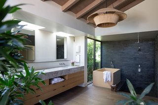 The luxurious step-down ensuite bathroom has a shower, Japanese-style soaking tub, and extensive closet space, plus a vanity. 