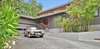 Modern home with Outdoor, Front Yard, Trees, Hardscapes, Raised Planters, Concrete Patio, Porch, Deck, Walkways, Metal Patio, Porch, Deck, Pavers Patio, Porch, Deck, and Wood Patio, Porch, Deck. Entry Photo of Portola Valley