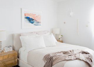 How to Design an Apartment You and Your Roommate Love - Photo 6 of 10 - White Linen Bedding: Parachute. Oatmeal Essential Quilt: Parachute. Mushroom Striped Cashmere Throw: Parachute. Morning River Print: Minted. Dean Sand Queen Upholstered Panel Bed: Living Spaces. Roar + Rabbit Brass Geo Nightstands: West Elm. Clear Disc Table Lamps: West Elm; Source: Amy Bartlam/Parachute