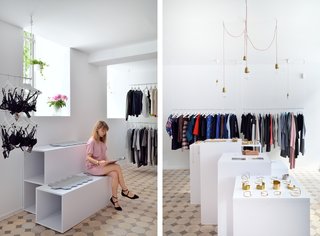 Combination of Old and New in a Fashion Store in Warsaw, Poland - Photo 1 of 4 - Clothes racks hang from the ceiling to add lightness and make the space feel bigger.