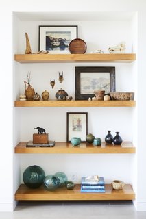 Installing wood shelves in this nook in a hallway adds visual interest that breaks up the hallway's length, and provides storage for books and other vignettes.