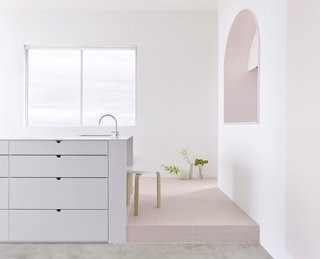 Elements:<br>Grey corian bench, Japanese industrial tile plinth and pink 2-Pac door and reveal<br><br>Photo: Haydn Cattach