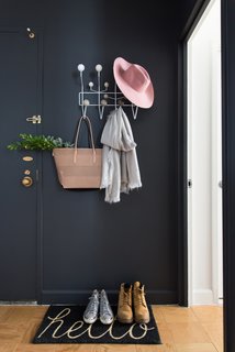 The Power of Color and What Each Shade Is Best For - Photo 3 of 11 - While black walls aren't the first thing you may consider for an inviting foyer, the dark walls are often in soothing contrast to the bright sunlight directly outside. The dramatic color also brings anything bright and colorful into stark relief.
