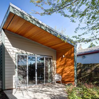 This 460-square-foot addition to a Cape Cod home adds much needed space for additional family members. The building's siding coordinates with the existing home, while the deep cedar overhang provides privacy from adjacent neighbors. 