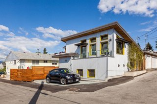 This 760-square-foot ADU is accessed off an alley in Vancouver, British Columbia, and serves as a home and office. The multilevel home takes advantage of its slope with a split-level plan that features an upper balcony. 