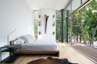 The roof of the wooden "box" portion of GriD's Spa Creek House contains the lofty master bedroom. The covered balcony enjoys commanding views across the creek to the historic district of Annapolis, Maryland.