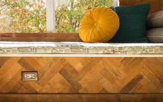The salvaged wood on the wall and window seat is from old subfloor on site.