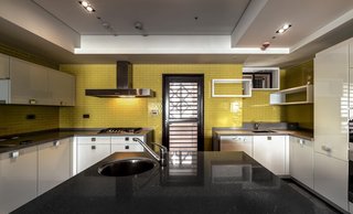 Natural Theme - Photo 16 of 17 - The yellow wall tiles in the kitchen were custom hand-made with glass and applied with enamel. They present a different sparkling and mirror effect which meets the expectations of the female owner for a modern atmosphere.