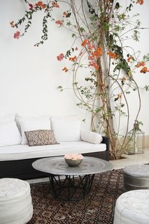 Moroccan rugs, leather poufs, and hand hammered silver tables make stark spaces comfortable.
