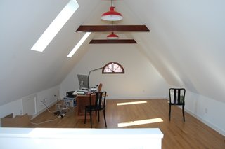 The skylights that descend into the wall plane bring in natural light and provide views of the historic neighborhood. 