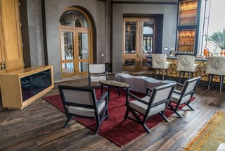 The floors are made from reclaimed wood found in the local region; the chairs are upholstered in American and Spanish textiles. 