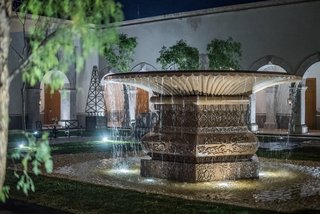 The outdoor water feature does double duty; it also serves as a water replenishment well for plants and vegetation. 