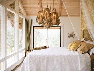 Designer and dressmaker Kristie Wolfe built this tiny off-grid getaway on the Big Island for just $11,000. It operates on solar panels, a rooftop rainwater catchment system and a toilet-sink combo that sends used water from the sink to the flusher. 