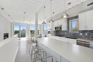 This luxury modern beach home, located on the dunes in Amagansett, New York, was constructed in modular units from repurposed steel shipping containers. Beach Box, which is located about 600 feet from the ocean, was built with EcoTop counters, tankless water heating, a 16 SEER HVAC unit, spray foam insulation, a white thermoplastic roof, Energy Star appliances, FSC-certified cypress siding and decking, and white oak floors. 