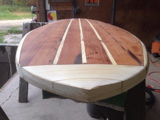 Before shaping the nose. The small hole in the deck allows for a screw-in plug later, necessary to vent air from the hollow core after each surf. Air trapped inside the board expands with heat, creating pressure.