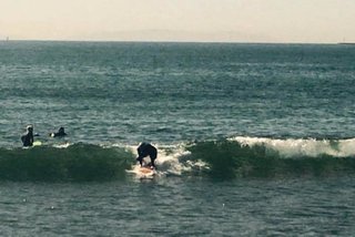 Paddling in, standing up.