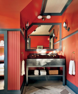  Shope Reno Wharton designer Thom Filicia got playful with this navy-and-red guest bath in an Adirondacks home. 