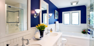 Minor changes to the layout of a modestly sized master bath transformed it into the space of these homeowners’ dreams. Designer Gail Drury downsized the vanity and moved the toilet a few feet to allow for an addition of a whirlpool tub and new shower enclosure. A former linen closet accommodates the new glass shower enclosure. Other space-saving tricks include the addition of a shallow-depth linen cabinet, decorative open shelving, and an open vanity to make the room appear more spacious.