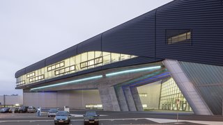 The central building is the nerve center for BMW's new $1.55 billion complex built to manufacture the BMW 3 Series vehicle. Hadid's design took the idea of connectivity and used it to inform every aspect of the new building. It serves as a connection for the assembly process steps and the employees. Designed as a series of overlapping and interconnecting levels and spaces, it blurs the separation between parts of the complex and creates a level ground for employees, visitors, and the cars.