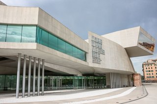 Hadid described this museum as "not an object-container, but rather a campus for art" where flows and pathways overlap and connect in order to create a dynamic and interactive space. Entering the atrium, the main elements of the project are evident: concrete curved walls, suspended black staircases, and an open ceiling that catches natural light. By implementing these elements, Hadid intended to create "a new fluid kind of spatiality of multiple perspective points and fragmented geometry, designed to embody the chaotic fluidity of modern life."