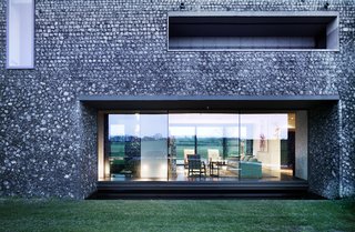 These 4 Modern Homes Around the World Take Advantage of Local Stone - Photo 11 of 16 - A dark, almost black mortar on the lower portion of the home makes it feel grounded in the landscape.