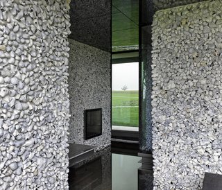 These 4 Modern Homes Around the World Take Advantage of Local Stone - Photo 12 of 16 - On the upper floor, smaller stones of lighter colored flint cover the walls. 