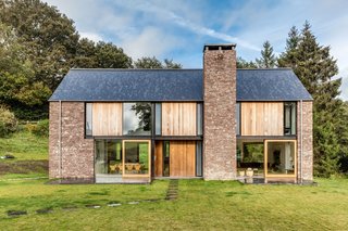 These 4 Modern Homes Around the World Take Advantage of Local Stone - Photo 16 of 16 - The other facades have wood panels as well as local red sandstone. 