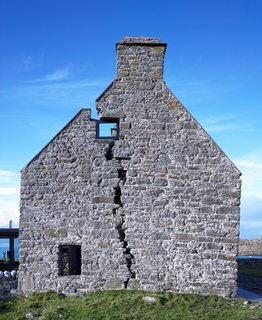 The deep fissure through the end gable of the home was due to settlement of sand below the ground, but it also gives the home its distinctive character.