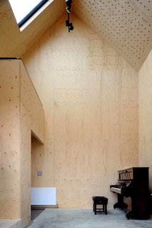 A north-facing skylight provides constant, even daylighting for musicians and artists staying in the studio and lightens the plywood interiors.