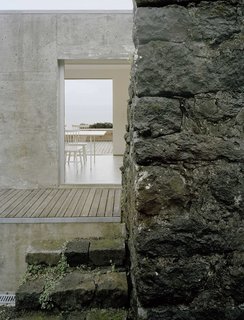 Because the site is sloped, the lower level of the home acts as a terrace for the upper level.