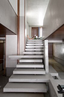 The interior of the Olivetti showroom by Carlo Scarpa features a range of materials in a jewel box-like way, including terrazzo, concrete, mosaic, metals, and wood.