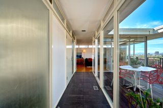 A Midcentury-Modern Home in L.A. Designed by Richard Banta Is For Sale For $899K - Photo 9 of 13 - A narrow hallway with black slate tile connects the two wings of the house.