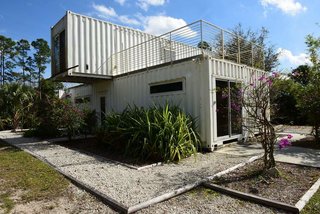 Functioning as a vacation rental for tourists, entrepreneur Rick Clegg combined old shipping containers to create a four-bedroom home with an eco twist near Palm Beach, Florida. Because of the container's inherent durability, they meet Florida's stringent construction standards. The compactness of the home; its low carbon footprint because of the use of the recycled, prefabricated containers; and the home's proximity to the Loxahatchee River make it ideal for ecotourists. 