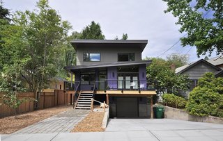 Inspired by the traditional shingle-clad homes in the neighborhood, this prefab was based off a design by Method Homes and then customized by Grouparchitect to accommodate the client’s needs, as well as the unique site. Doors were widened, a rear porch was enclosed for an additional bedroom, and specialized storage was added, including an enlarged laundry room, a generous pantry, and built-in cubbies for each member of the family. 