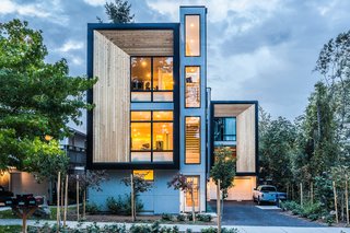 Consisting of three prefabricated units in West Seattle on a 5,000-square-foot lot, the townhomes range from 1,250 to 1,400 square feet, and each have three bedrooms and two and a half bathrooms. The generous glazing of the living rooms are set back from the exterior cedar rainscreen, and the rest of the facade is sheathed in metal panels. The ground floor was built onsite, and the upper two floors were prefabricated offsite in a factory. 
