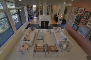 The living room, with its focus on the fireplace and expansive views to the exterior, is also open to the dining area.