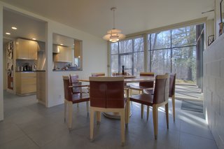 The dining room has direct access to an enclosed porch through a sliding glass door.