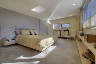 The three bedrooms are in a separate wing and feature long, higher-up windows, which let in ample sunlight but also provide plenty of privacy.