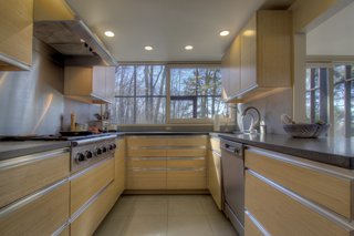 The kitchen, dining, and living areas are located on one side of the home, and are separated from the bedrooms on the other end.