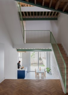 Located in the center of the home, the simple, yet striking staircase connects three floors.