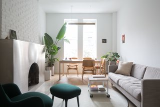 Bold, saturated tones contrast beautifully with the metallic finishes and neutral colors that characterize the furnishings in the living room.