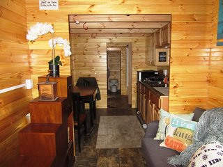 Real Wood Tiny Homes designs tiny homes and compact pre-engineered buildings that are transportable, semi-permanent, or permanent. Their buildings all use a unique tongue-and-groove construction technique where wood boards interlocks with adjacent pieces—the wood is also treated for fire protection and rot. The homes are designed to be sustainable, and feature a proprietary water cycle management system that conserves fresh water, collects rainwater, and recycles gray water for irrigation.