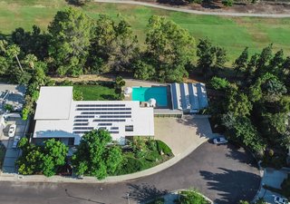 The five bedroom, five bathroom home is sited on over half an acre of land, and sits adjacent to a local golf course. The owners have installed solar panels on the roof.