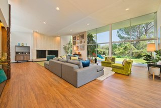 The open living room features Adachi's signature inverted-butterfly ceiling for a sense of height, drama, and movement in the space.