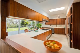 The original kitchen boasts modern updates, including a Sub Zero refrigerator/freezer, a Gaggenau electric grill/griddle, and Kitchen Aid stainless steel appliances.