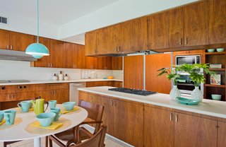 The charming kitchen retains its original walnut cabinets.