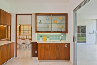 An updated bar area is conveniently adjacent to the kitchen and the outdoor patio.