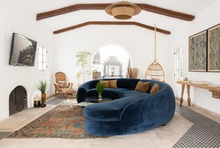 Overhead ceiling beams and a unique light fixture make the ceiling an important presence in the room.